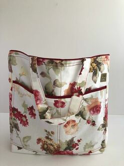 صورة حقيبة قماش كبيرة وانيقة لحمل اغراض الزيارة او الشالية لونها ابيض مزينة بالورد
